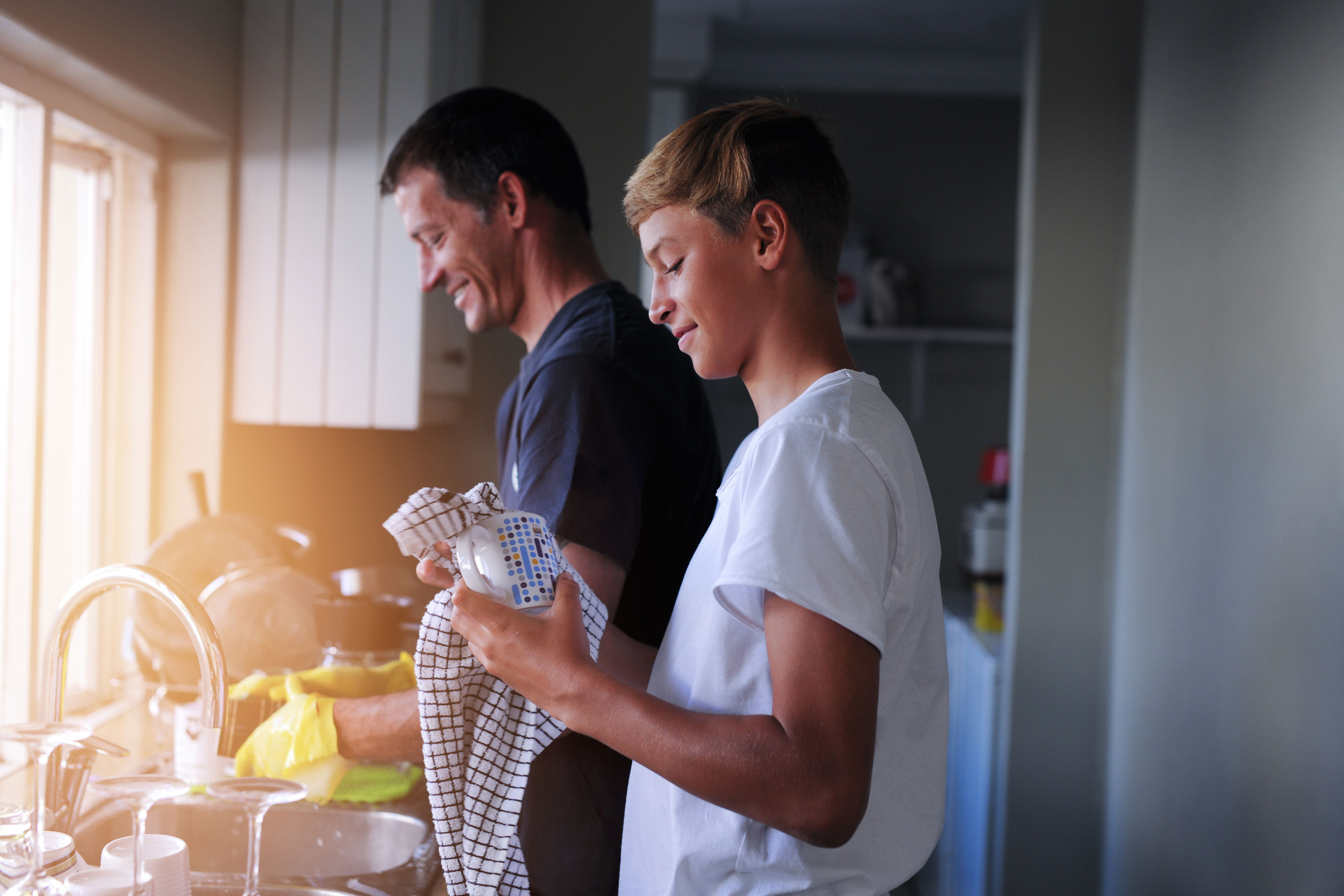 Father and son washing dishes 