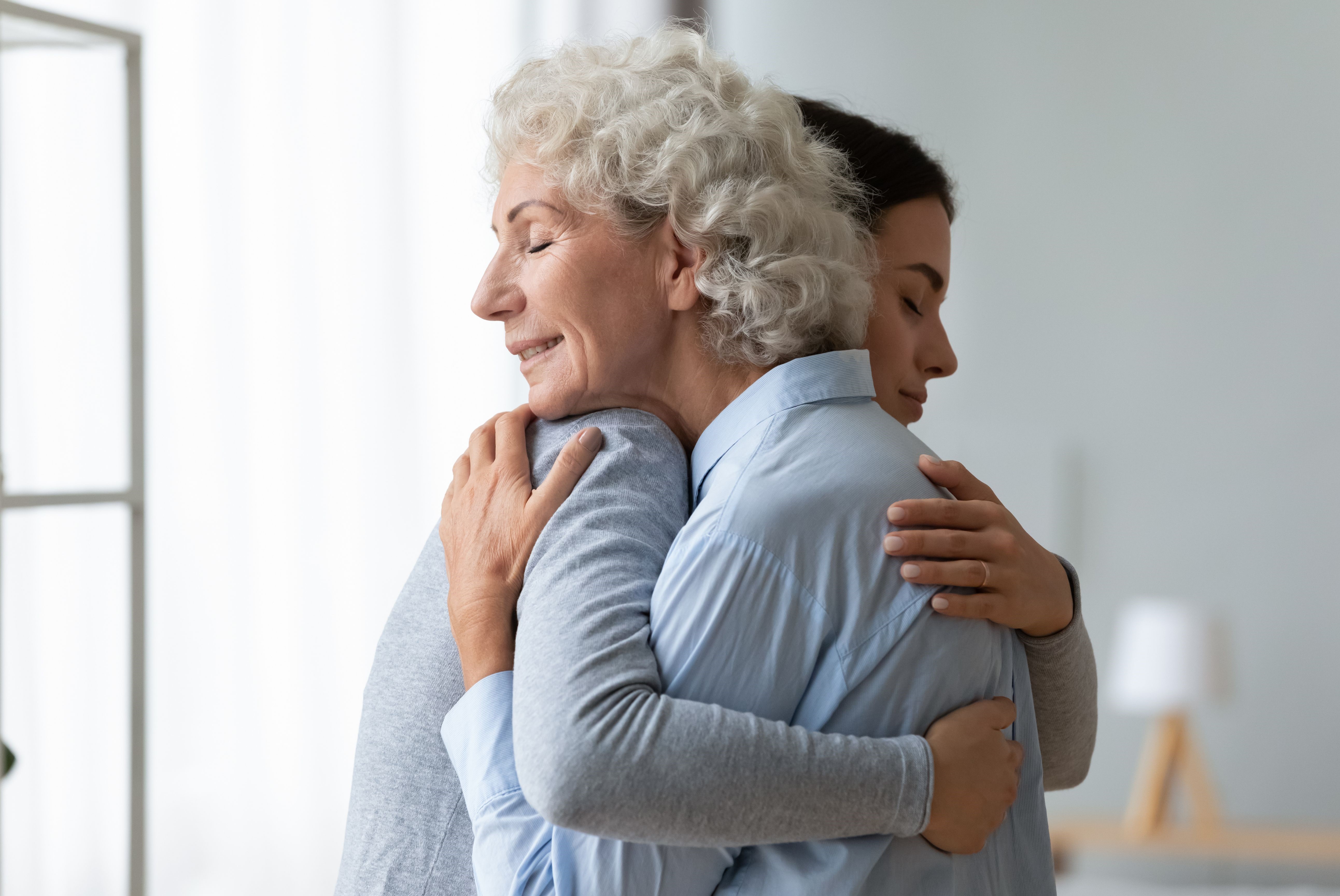 Mother and adult daughter embrace