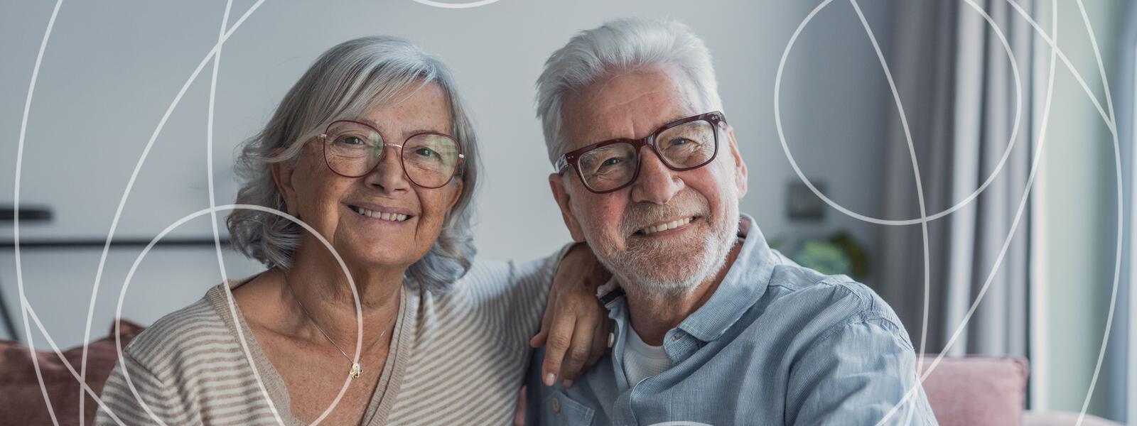Older adult couple smiles at the camera