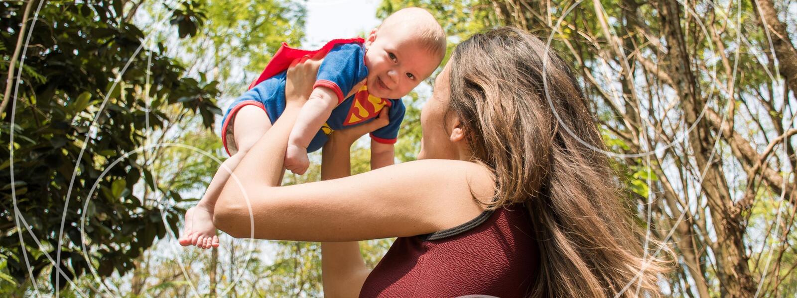 mom lifts baby into air