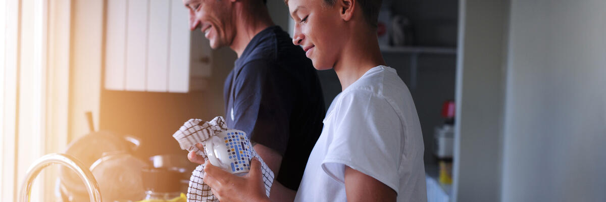 Father and son washing dishes