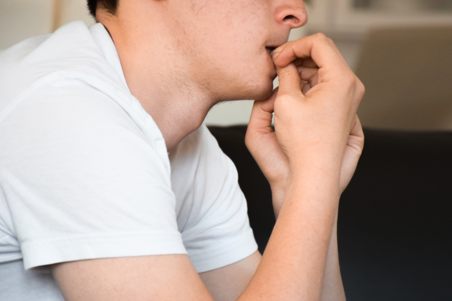 A person bites their nails