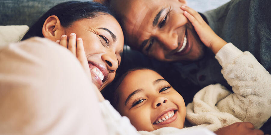 Family of three hugging