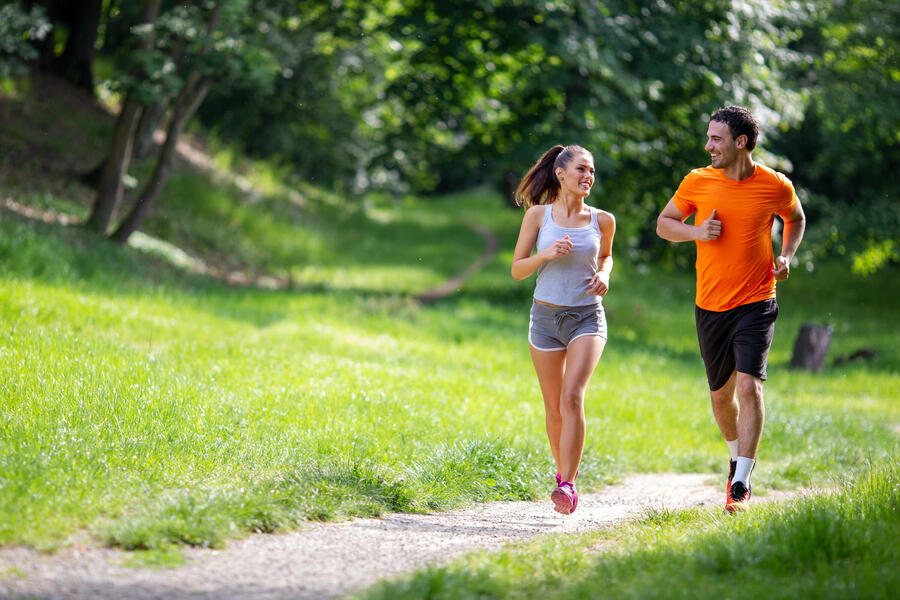 man and woman running on path