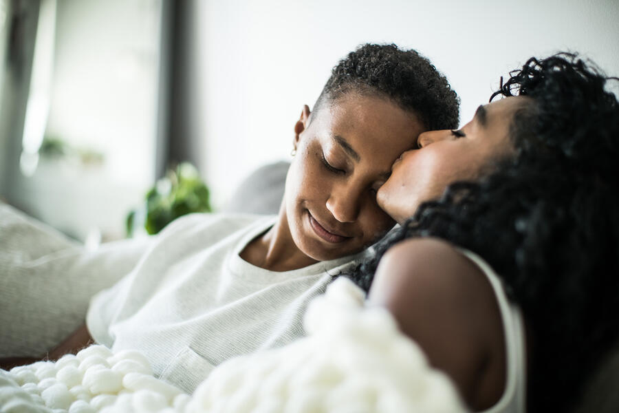 two_women_forehead_kiss