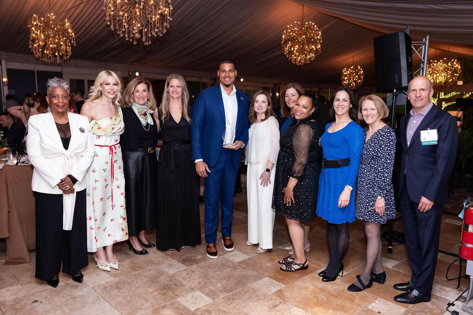 Ryan Poles stands with The Family Institute's president and CEO as well as several members of its Board of Directors.