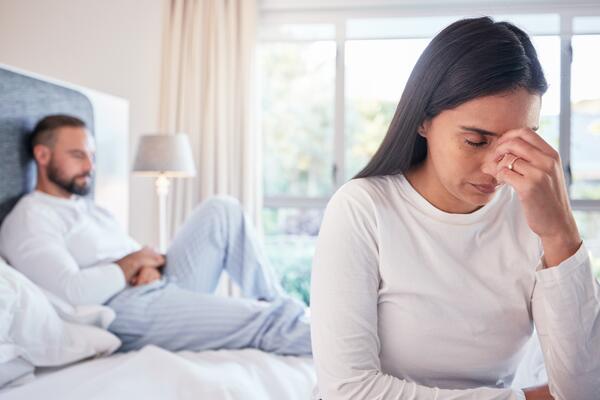 Stressed couple in their bedroom