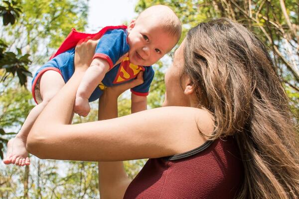 mom lifts baby into air